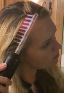 Lady curling her hair.