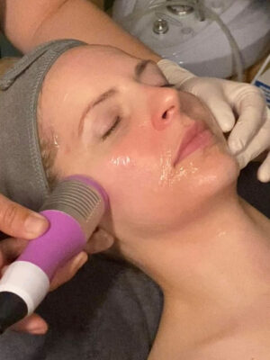 Woman receiving a glacial treatment for her face.