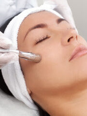 Lady on bed receiving Microdermabrasion and Oxygen Trio Treatment.