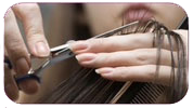 Woman cutting hair.